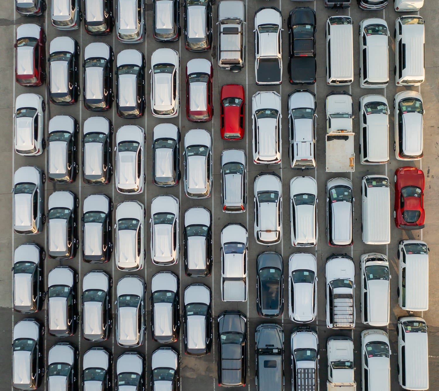 Aerial shot of a carpark full of cars, trucks and vans