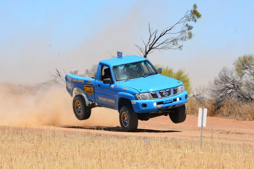 Partially airborne truck on a dirt race track